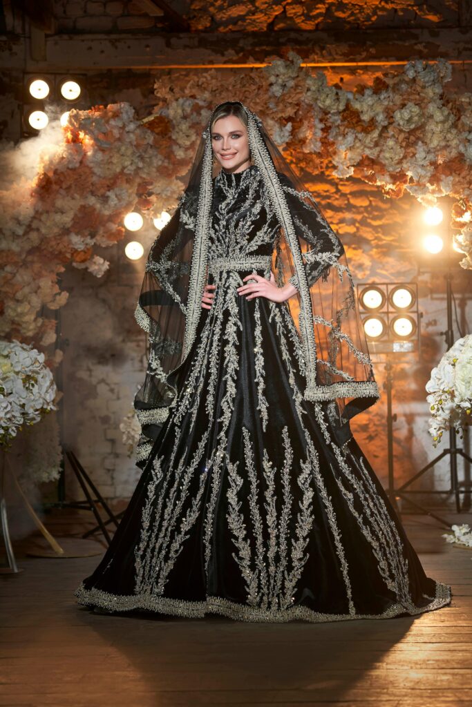 Elegant portrait of a bride in a detailed black and white gown with veil.