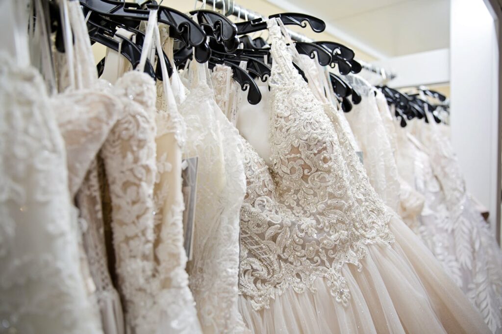 Beautiful lace wedding dresses on display in a bridal boutique, showcasing intricate designs and elegance.